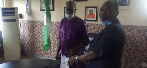 Mr. Shonde Oludotun, presents a souvenir to Mr. Istifanus Baba, Director FRCN Lagos, on behalf of PMG NIPOST, Dr. Ismail Adewusi, during a visit to Ikoyi.
